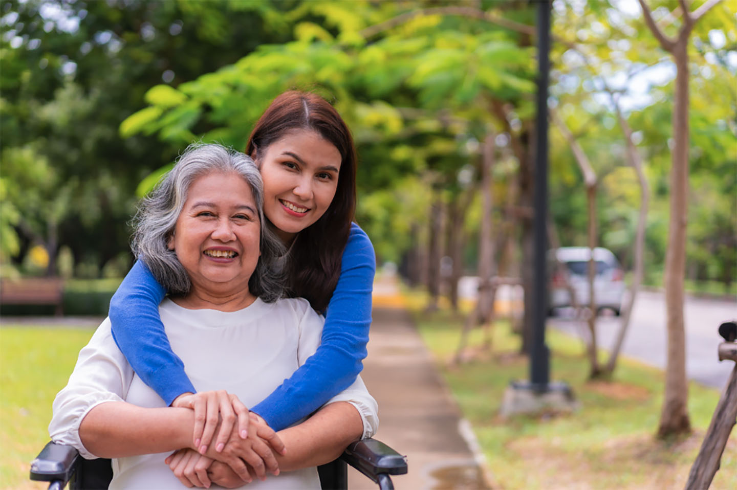 Daughter hugging aging loved-one